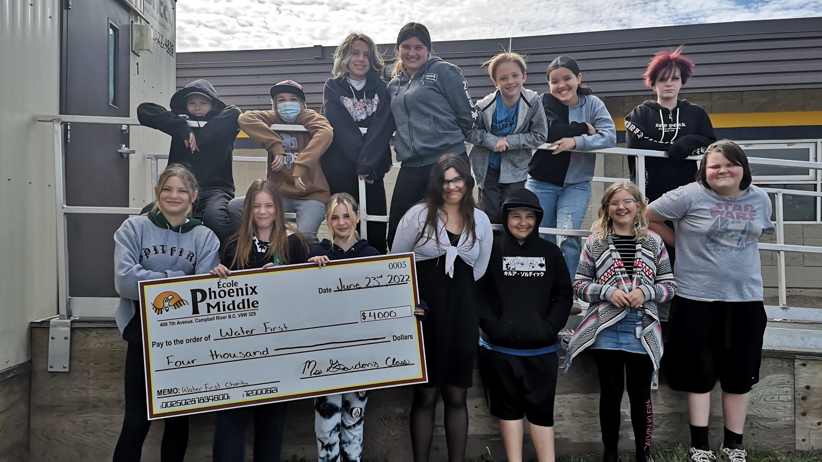 Students from Ms. Gordon's 6/7 class with the cheque that they will present Water First.